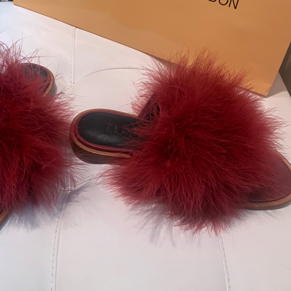 Burgundy feather mules.